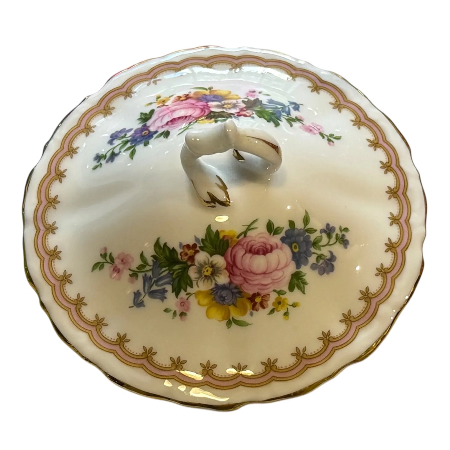 A vintage Royal Albert porcelain lidded serving dish, featuring a scalloped rim with gold detailing, a floral pattern with pink, blue, yellow, and green flowers, and a ceramic handle on top, set against a plain white background.